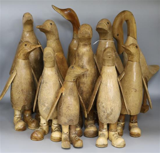 Ten carved ducks and penguins